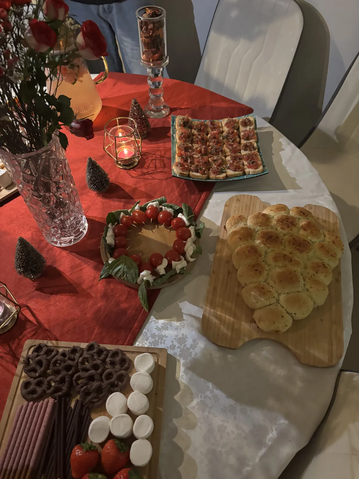 Christmas tablescape details with candles, mini trees and platters